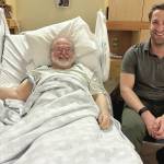 Dr. Lars Matkin sits with a happy patient post-surgery in January at South Peninsula Hospital. The surgery marks the first time in recent years that a hip replacement was done locally. (Photo courtesy of South Peninsula Hospital)