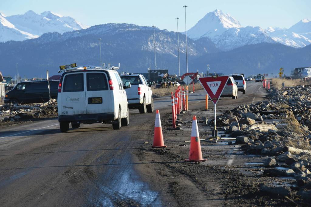 Cars yield to oncoming traffic before commuting south on the single open lane of Homer Spit Road on Monday, Nov. 18, 2024, following significant erosion damage to the highway that occurred on Saturday in Homer, Alaska. (Delcenia Cosman/Homer News)