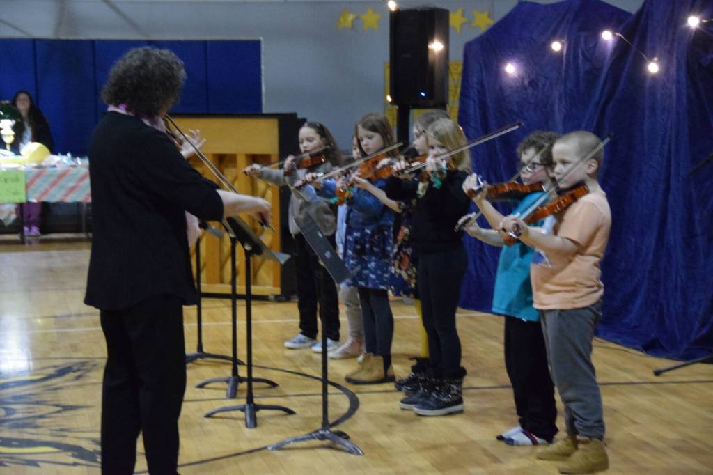 Nancy Chambers (left) leads the Chapman Eagle Ensemble, part of Homer OPUS, in playing Twinkle Twinkle Little Star during the Cabin Fever Variety Show on Thursday, Feb. 27, 2025, in the Chapman School gym as part of the 2025 Snow Rondi in Anchor Point, Alaska. (Delcenia Cosman/Homer News)