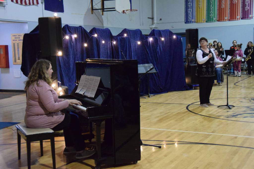 Chapman School first grade teacher Rachel Ostler (left) provides piano accompaniment to her mother, Cara Long, as she sings Bette Midlers The Rose during the Cabin Fever Variety Show on Thursday, Feb. 27, 2025, in the Chapman School gym as part of the 2025 Snow Rondi in Anchor Point, Alaska. (Delcenia Cosman/Homer News)
