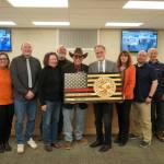Retired Kachemak Emergency Services Chief Robert Cicciarella, center, is honored by the Kenai Peninsula Borough Assembly during their meeting in Soldotna, Alaska, on Tuesday, Feb. 25, 2025. (Jake Dye/Peninsula Clarion)