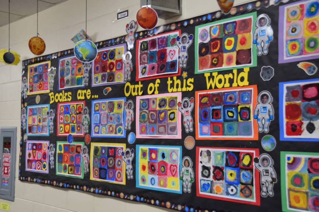 A poster showcasing student art hangs in the hallway of Paul Banks Elementary School on Feb. 28, 2025. (Chloe Pleznac/Homer News)