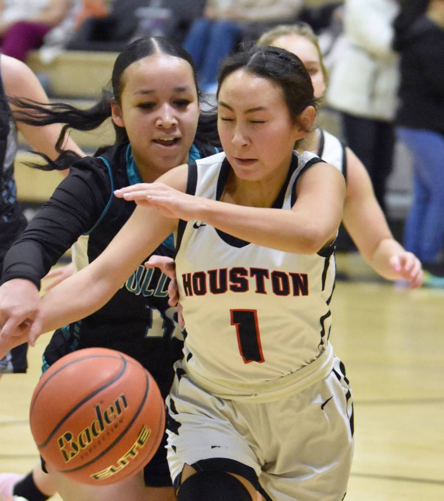 Houstons Tricity Curren and Nikiskis Madison Iyatunguk battle for the ball Friday, February 28, 2025, at Nikiski Middle-High School in Nikiski, Alaska. (Photo by Jeff Helminiak/Peninsula Clarion)