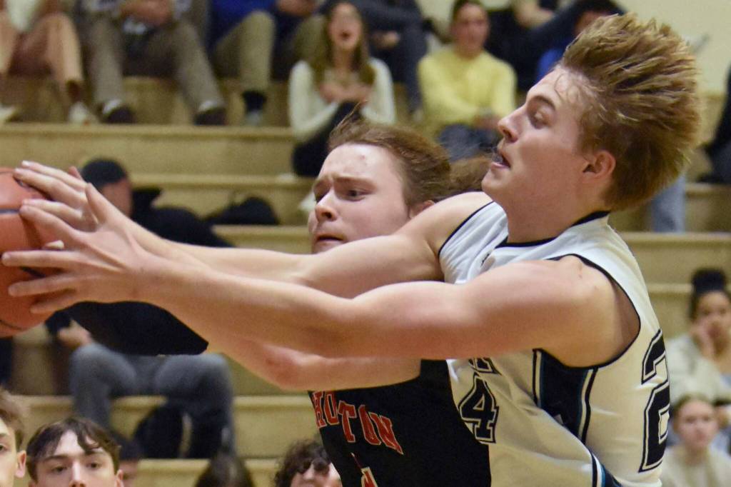Nikiski's Ethan Ellis and Houston's Ethan Slaton battle for the ball Friday, February 28, 2025, at Nikiski Middle-High School in Nikiski, Alaska. (Photo by Jeff Helminiak/Peninsula Clarion)