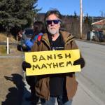 Wes the Mess Shacht holds up a sign during the Stand for Democracy Rally on International Womens Day, March 8, 2025, at WKFL Park in Homer, Alaska. (Chloe Pleznac/Homer News)