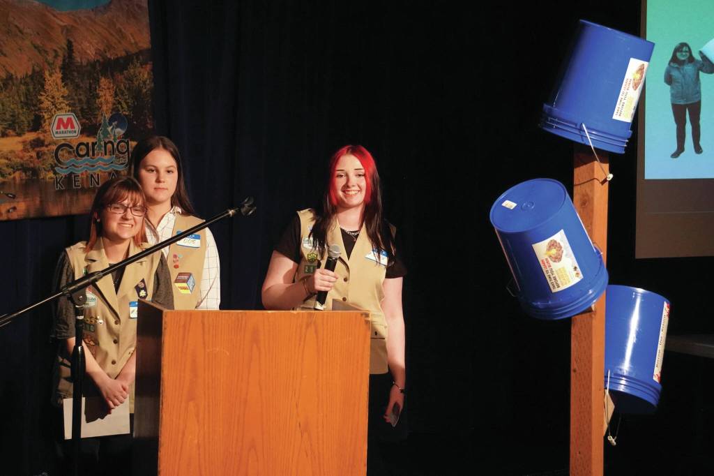 Girl Scout Troop 210, which includes Caitlyn Eskelin, Emma Hindman, Kadie Newkirk and Lyberty Stockman, present their "Bucket Trees" to a panel of judges in the 34th Annual Caring for the Kenai Competition at Kenai Central High School in Kenai, Alaska, on Thursday, April 18, 2024. (Jake Dye/Peninsula Clarion)