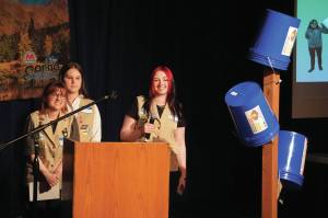 Girl Scout Troop 210, which includes Caitlyn Eskelin, Emma Hindman, Kadie Newkirk and Lyberty Stockman, present their "Bucket Trees" to a panel of judges in the 34th Annual Caring for the Kenai Competition at Kenai Central High School in Kenai, Alaska, on Thursday, April 18, 2024. (Jake Dye/Peninsula Clarion)