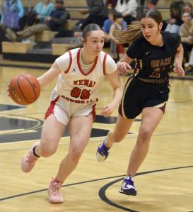 Kenai Centrals Sierra Hershberger drives on Grace Christians Jaden Helton on Saturday, March 8, 2025, at the Peninsula Conference tournament at Nikiski Middle-High School in Nikiski, Alaska. (Photo by Jeff Helminiak/Peninsula Clarion)