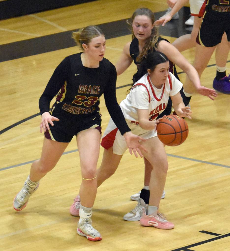 Kenai Centrals Evelyn Cooper passes under pressure from Grace Christians Sophie Lentfer and Hope Jackson on Saturday, March 8, 2025, at the Peninsula Conference tournament at Nikiski Middle-High School in Nikiski, Alaska. (Photo by Jeff Helminiak/Peninsula Clarion)
