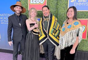 Wáatsasdiyei Joe Yates, Raye Lankford, X̱unei Lance Twitchell and Rochelle Adams pose with the Childrens and Family Emmy Award award Lankford and Twitchell won for co-writing the an episode of the PBS animated childrens show Molly of Denali. (Photo courtesy of Wáatsasdiyei Joe Yates)