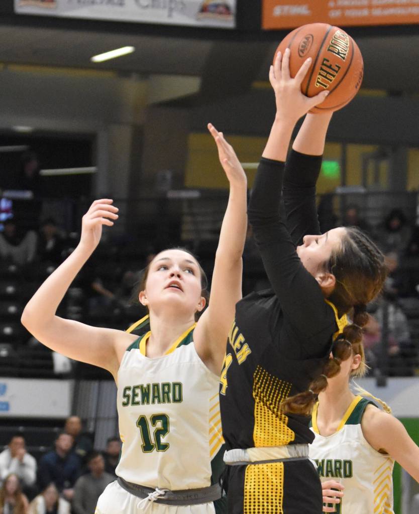 Sewards Mikinley Williams battles Glennallens Koiana Cooley for the ball at the Class 2A girls state championship game Saturday, March 15, 2025, at the Alaska Airlines Center in Anchorage, Alaska. (Photo by Jeff Helminiak/Peninsula Clarion)