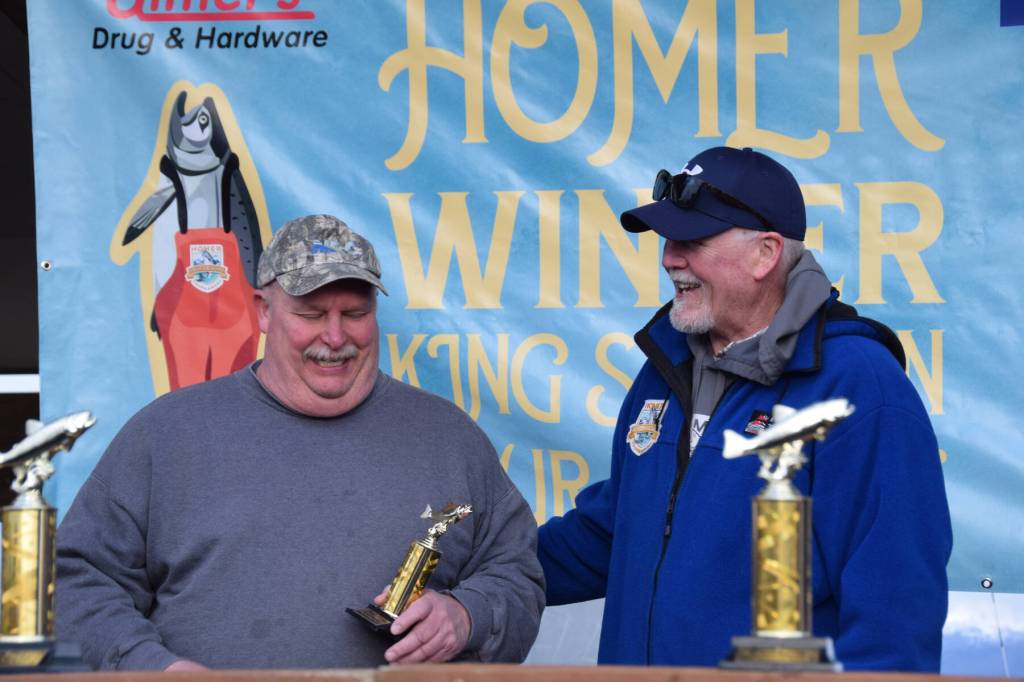 John Raymond accepts his tenth place trophy during the 2025 Homer Winter King Salmon Tournament on Saturday, March 22, 2025, at the Deep Water Dock on the Homer Spit in Homer, Alaska. (Delcenia Cosman/Homer News)