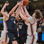 Kenais Miles Metteer, Homers Einar Pederson (4) and Henry Wedvik (22) and Kenais Mason Tunseth (33) battle for a rebound on Thursday, March 20, 2025, in their consolation bracket semifinal during the 2025 ASAA March Madness Alaska 3A/4A Basketball State Championships at the Alaska Airlines Center in Anchorage, Alaska. (Klas Stolpe / Juneau Empire)