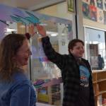 Youth Services Librarian Cinda Nofziger points to a puzzle piece just placed on the Summer Reading Program sponsorship puzzle during the Celebration of Lifelong Learning on Saturday, March 29, 2025 at the Homer Public Library. Pieces can be purchased for $25 and each one sponsors a summer of reading for a local young person. (Chloe Pleznac/Homer News)
