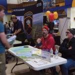 Captains Curtis Jackson and Mako Haggerty of Makos Water Taxi talk with a student on Friday, March 28, 2025 in the Homer High School commons. (Delcenia Cosman/Homer News)