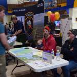 Captains Curtis Jackson and Mako Haggerty of Makos Water Taxi talk with a student on Friday, March 28, 2025 in the Homer High School commons. (Delcenia Cosman/Homer News)