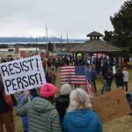Protesters in Homer hold up signs during the nationwide Hands Off! protest on Saturday, April 5 at WKFL Park in Homer, Alaska. (Chloe Pleznac/Homer News)