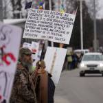 Protesters stand along the Sterling Highway in Soldotna, Alaska, participating in the Remove, Reverse, Reclaim protest organized by Many Voices and Kenai Peninsula Protests as part of the nationwide 50501 effort on Saturday, April 5, 2025. (Jake Dye/Peninsula Clarion)