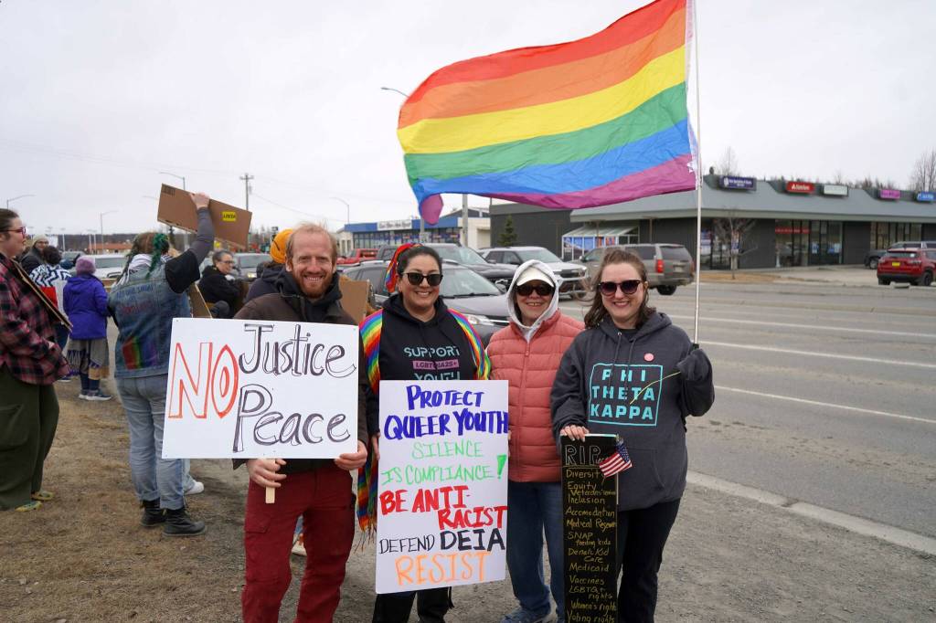 Protesters stand along the Sterling Highway in Soldotna, Alaska, participating in the Remove, Reverse, Reclaim protest organized by Many Voices and Kenai Peninsula Protests as part of the nationwide 50501 effort on Saturday, April 5, 2025. (Jake Dye/Peninsula Clarion)