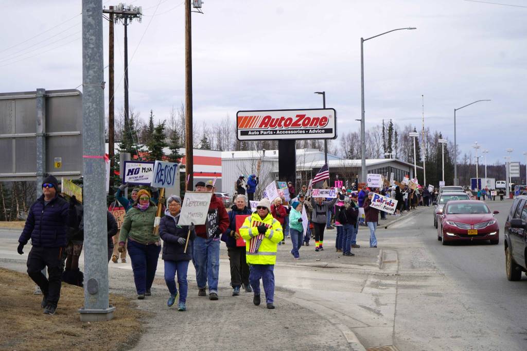 Protesters stand along the Sterling Highway in Soldotna, Alaska, participating in the Remove, Reverse, Reclaim protest organized by Many Voices and Kenai Peninsula Protests as part of the nationwide 50501 effort on Saturday, April 5, 2025. (Jake Dye/Peninsula Clarion)