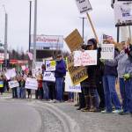 Protesters stand along the Sterling Highway in Soldotna, Alaska, participating in the Remove, Reverse, Reclaim protest organized by Many Voices and Kenai Peninsula Protests as part of the nationwide 50501 effort on Saturday, April 5, 2025. (Jake Dye/Peninsula Clarion)