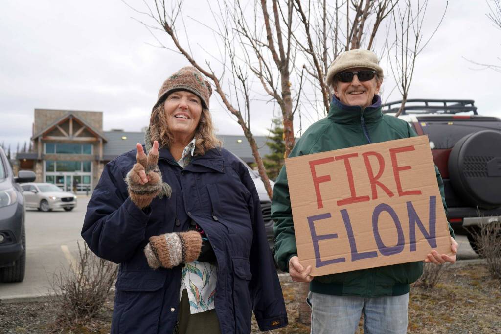 Protesters stand along the Sterling Highway in Soldotna, Alaska, participating in the Remove, Reverse, Reclaim protest organized by Many Voices and Kenai Peninsula Protests as part of the nationwide 50501 effort on Saturday, April 5, 2025. The woman on the left said she was calling for peace in Ukraine. (Jake Dye/Peninsula Clarion)