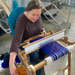 Homer weaver Lisa Talbott weaves a scarf during the 2023 Ready Set Art fundraiser at Grace Ridge Brewing. (Photo by Christina Whiting/Homer News)