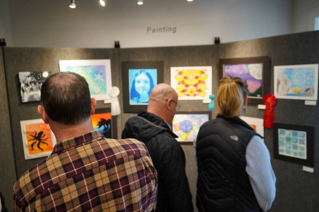 Attendees view the 34th Annual Visual Feast Kenai Peninsula Borough School District Juried Student Art Show during an opening reception at the Kenai Art Center in Kenai, Alaska, on Friday, April 4, 2025. (Jake Dye/Peninsula Clarion)