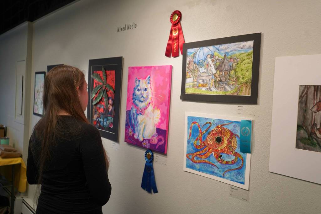 Attendees view the 34th Annual Visual Feast Kenai Peninsula Borough School District Juried Student Art Show during an opening reception at the Kenai Art Center in Kenai, Alaska, on Friday, April 4, 2025. (Jake Dye/Peninsula Clarion)