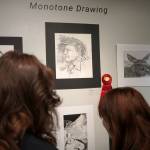 Attendees view the 34th Annual Visual Feast Kenai Peninsula Borough School District Juried Student Art Show during an opening reception at the Kenai Art Center in Kenai, Alaska, on Friday, April 4, 2025. (Jake Dye/Peninsula Clarion)