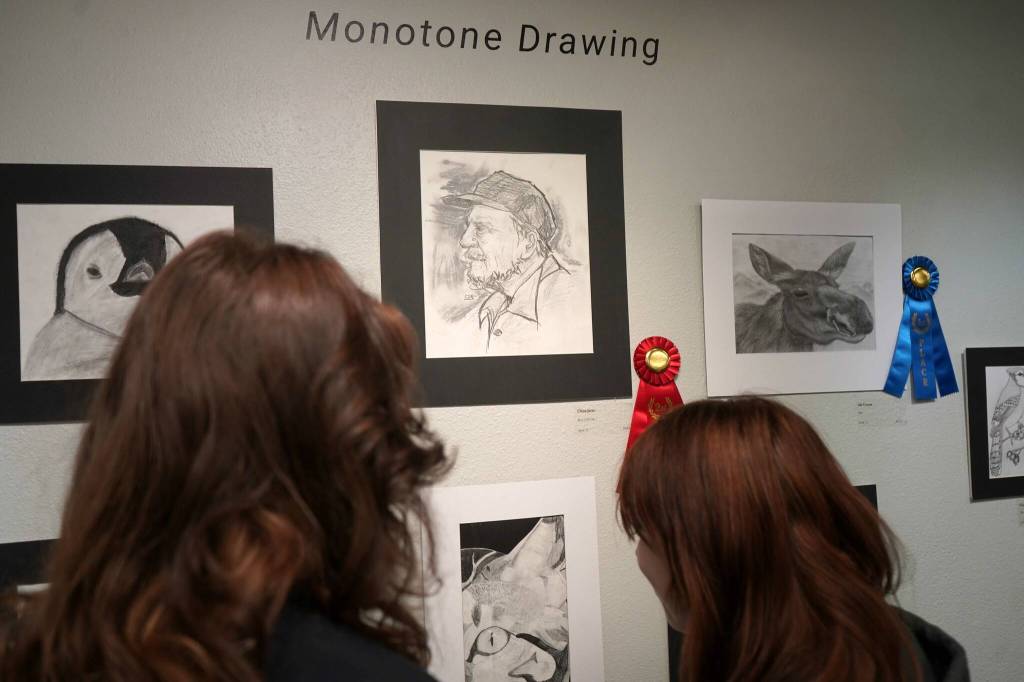 Attendees view the 34th Annual Visual Feast Kenai Peninsula Borough School District Juried Student Art Show during an opening reception at the Kenai Art Center in Kenai, Alaska, on Friday, April 4, 2025. (Jake Dye/Peninsula Clarion)