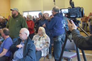 Chloe Pleznac/Homer News
Community members who support education funding stand up during the virtual town hall with Rep. Sarah Vance on Saturday in the Pioneer Hall at Kachemak Bay Campus.