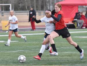 Homers Julianne Techie and Kenai Centrals Christine Goering battle for the ball Thursday, April 17, 2025, at Ed Hollier Field at Kenai Central High School in Kenai, Alaska. (Photo by Jeff Helminiak/Peninsula Clarion)
