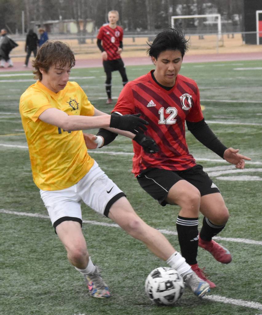Homers Kai Waltenbaugh shields the ball from Kenai Centrals Enrique Mercado on Thursday, April 17, 2025, at Ed Hollier Field at Kenai Central High School in Kenai, Alaska. (Photo by Jeff Helminiak/Peninsula Clarion)