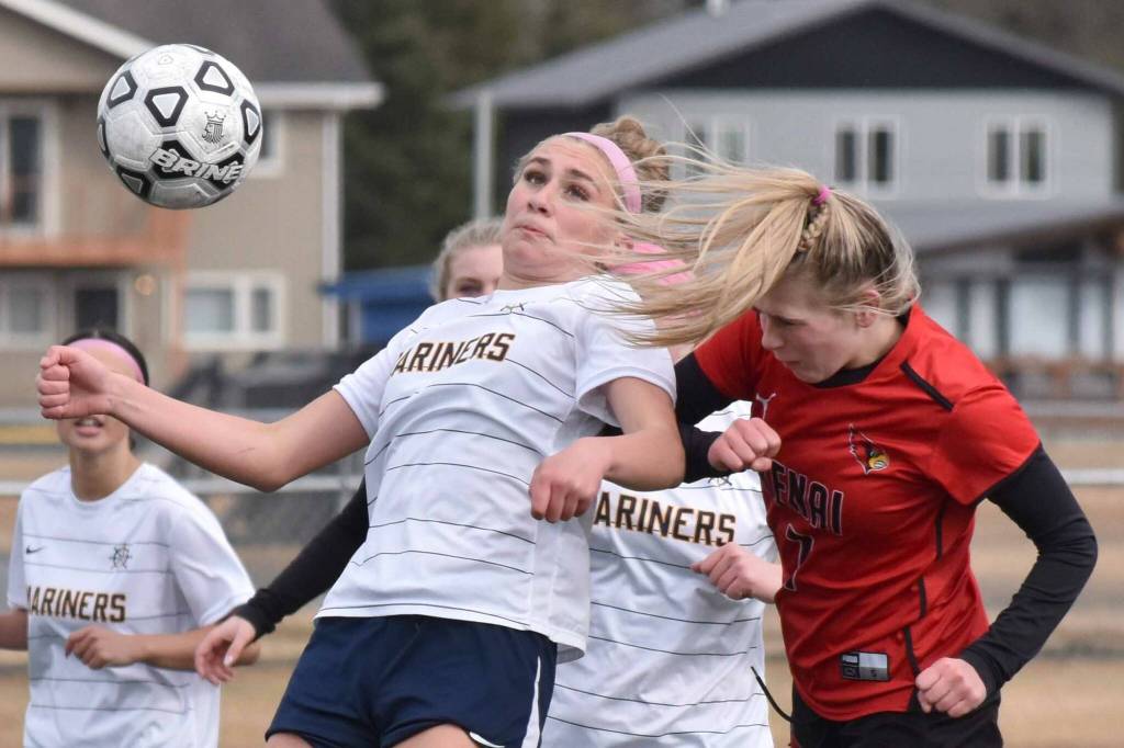 Homer's Ruby Hill and Kenai Central's Tait Cooper battle for the ball Thursday, April 17, 2025, at Ed Hollier Field at Kenai Central High School in Kenai, Alaska. (Photo by Jeff Helminiak/Peninsula Clarion)
