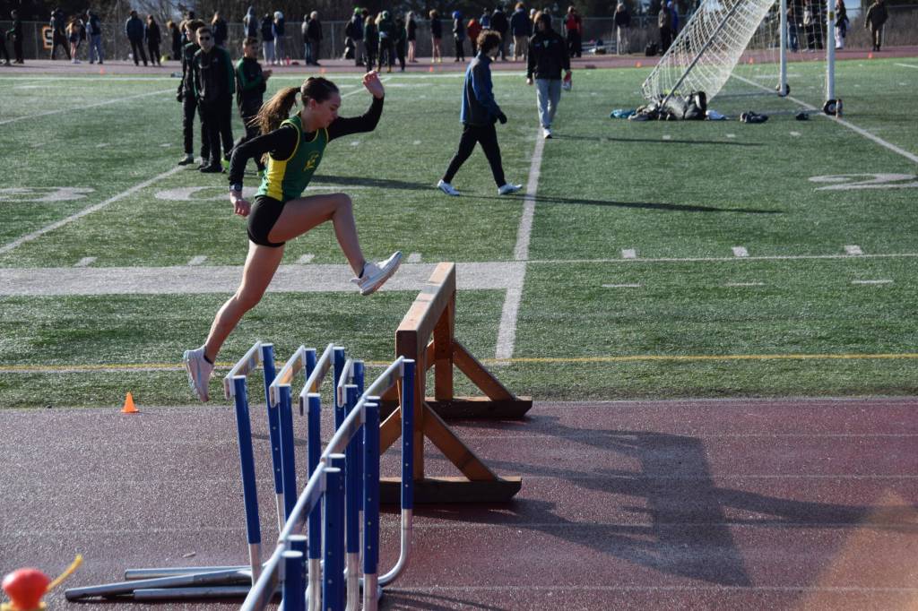 A steeplechaser takes a leap on Friday, April 18 at the Homer High School Invitational Track Meet. (Chloe Pleznac/Homer News)