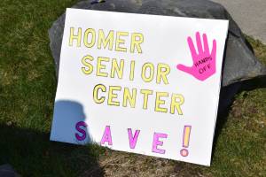 A sign in support of Homer Senior Citizens Inc rests on display at the Sustained Resistence, Makes a Difference rally on Saturday, April 19. (Chloe Pleznac/Homer News)