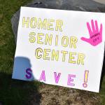 A sign in support of Homer Senior Citizens Inc rests on display at the Sustained Resistence, Makes a Difference rally on Saturday, April 19. (Chloe Pleznac/Homer News)