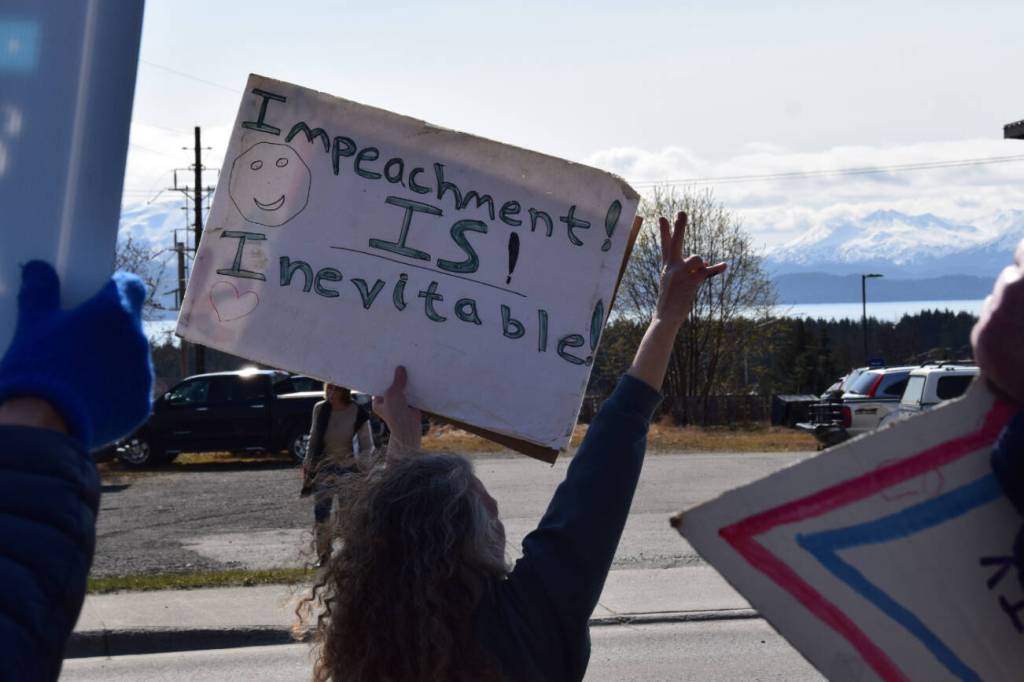 A protestor throws a peace sign on Saturday, April 19 at WKFL Park during the Sustained Resistence, Makes a Difference Rally. (Chloe Pleznac/Homer News)