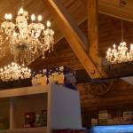 Chandeliers hang from the renovated ceiling in the Fritz Creek General Store on its reopening day on Thursday, April 24. (Chloe Pleznac/Homer News)