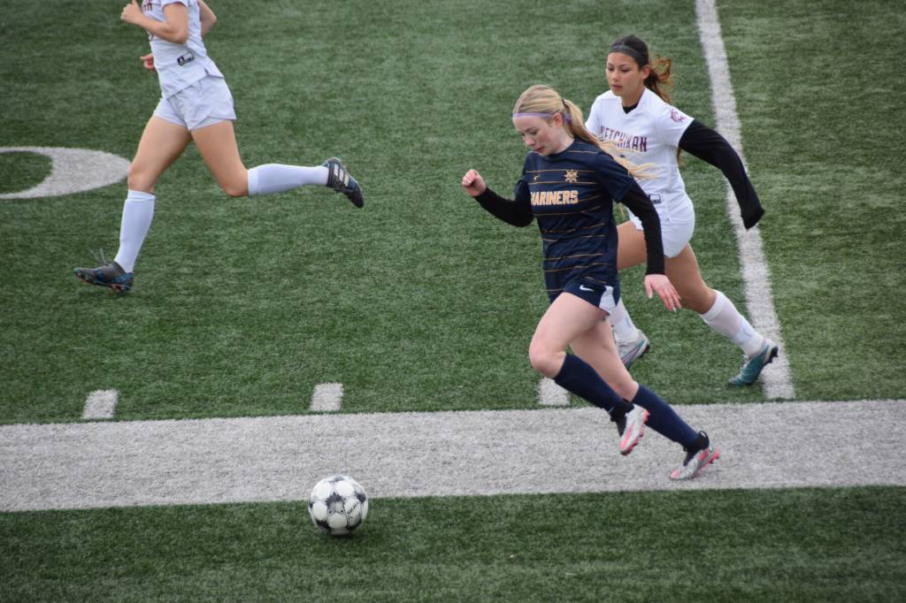 A Homer Mariner rushes for the ball during Saturdays soccer game at the Homer High School athletic field on April 26. (Chloe Pleznac/Homer News)