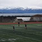 Homer players await the start of the first game of the day at the Homer High School athletic field on April 26. (Chloe Pleznac/Homer News)