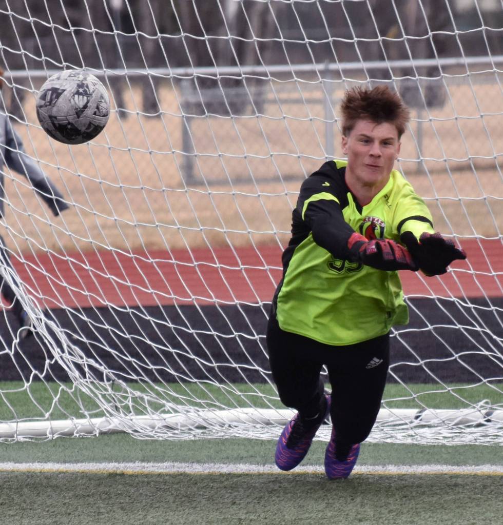 Kenai Central goalie Sawyer Vann saves a penalty kick Saturday, April 26, 2025, at Ed Hollier Field at Kenai Central High School in Kenai, Alaska. (Photo by Jeff Helminiak/Peninsula Clarion)