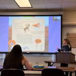 Nyla Klein displays a digital poster she created for her final practicum on Thursday, May 1, 2025, at Kachemak Bay Campus, in Homer, Alaska. (Chloe Pleznac/Homer News)