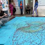 Students and family members appraise the Jackson Pollock-inspired art project in one of the classrooms at West Homer Elementary on Friday, May 2, 2025, during their annual Arts Extravaganza, in Homer, Alaska. (Photo courtesy of Amy Russell)
