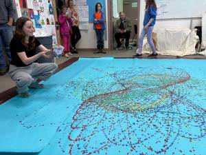 Students and family members appraise the Jackson Pollock-inspired art project in one of the classrooms at West Homer Elementary on Friday, May 2, 2025, during their annual Arts Extravaganza, in Homer, Alaska. (Photo courtesy of Amy Russell)