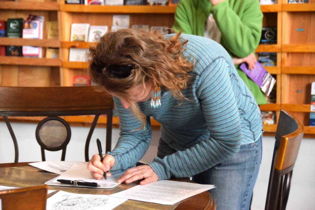 Homer Mayor Rachel Lord signs the Denim Day Prevention Proclamation during the first annual South Peninsula Haven House observation of Denim Day on Wednesday, April 30, 2025, at the Homer Chamber of Commerce in Homer, Alaska. (Delcenia Cosman/Homer News)