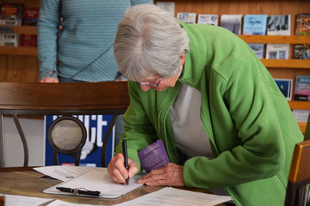 Sandra Garity, representing the Homer Women of Action, signs the Denim Day Prevention Proclamation during the first annual South Peninsula Haven House observation of Denim Day on Wednesday, April 30, 2025, at the Homer Chamber of Commerce in Homer, Alaska. (Delcenia Cosman/Homer News)