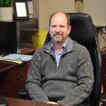 Douglas Waclawski sits at his desk in his office at Homer High School on Thursday, May 1. (Chloe Pleznac/Homer News)
