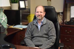 Douglas Waclawski sits at his desk in his office at Homer High School on Thursday, May 1. (Chloe Pleznac/Homer News)